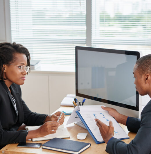 afro-american-man-suit-holding-documents-talking-female-boss